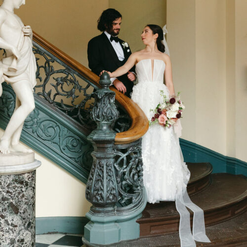 A couple standing on the Peabody Institute stairs.