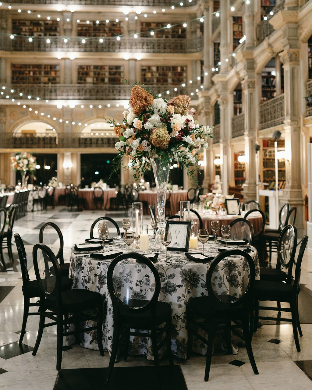 Madeline-Serio-Photography_Mollie-Sam_10-26-24 (72) A table with black chairs in the Peabody Library.