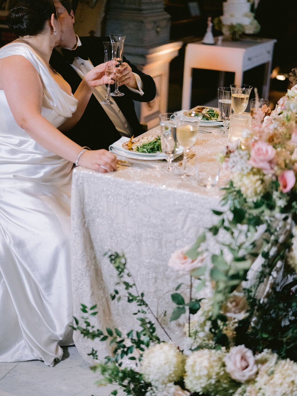 NikkiSanterre Photography_Emily&Daniel_9-1-24 (37) Couple kissing at the sweetheart table.