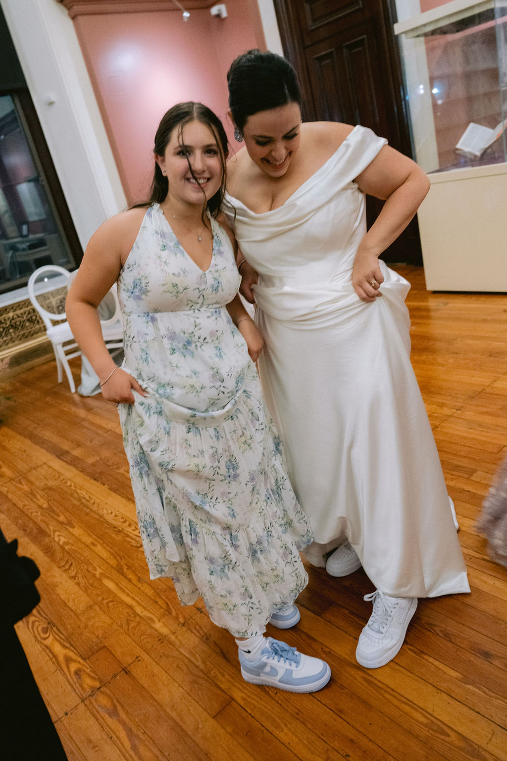 NikkiSanterre Photography_Emily&Daniel_9-1-24 (88) Bride and friend showing off their shoes.